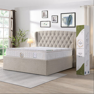 Mattress with tufted headboard and packaging in a bedroom setting