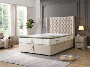 Beige mattress with tufted headboard in a bedroom setting