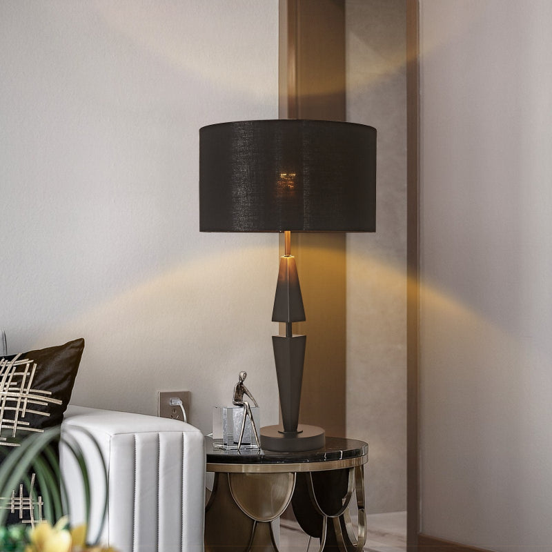 Modern lamp on a side table with a white wall and decorative elements in the background