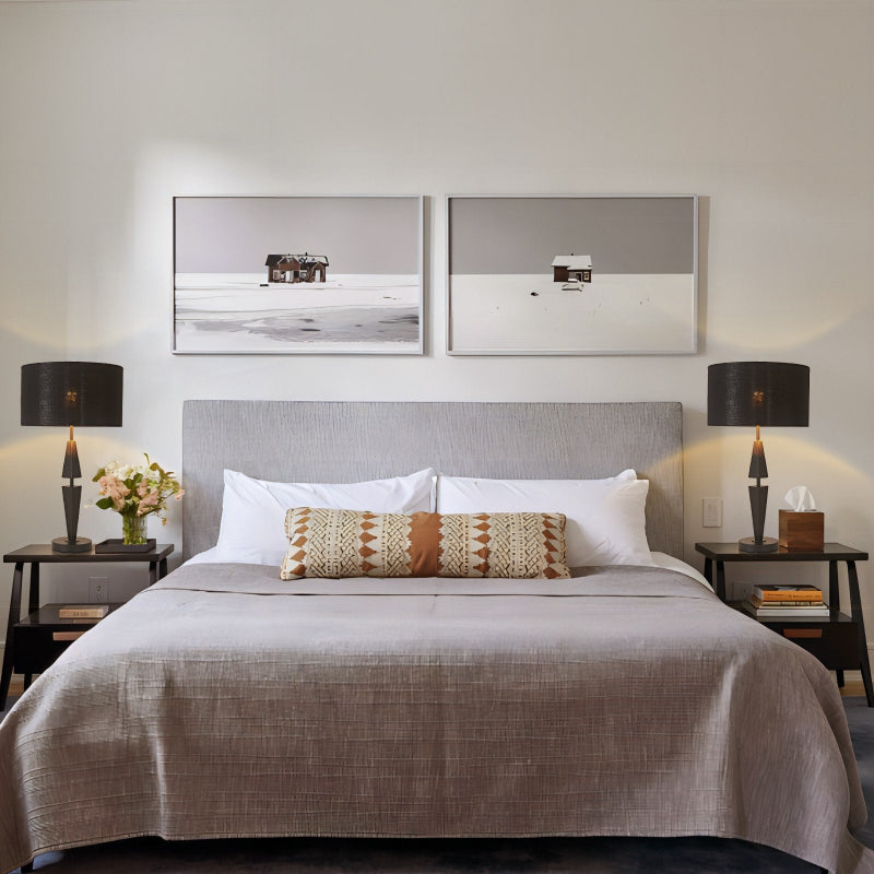 Modern bedroom with a bed, nightstands, and wall art.