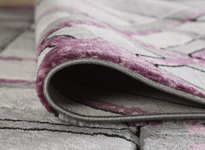 Accra Rug Close-up of a textured rug with pink and grey pattern
