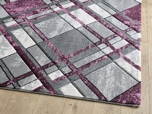 Acra rug Geometric patterned rug with purple and gray squares on a wooden floor