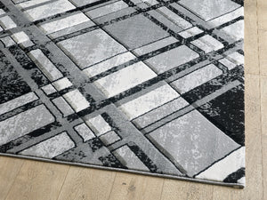 Gray and black checkered area rug on a wooden floor