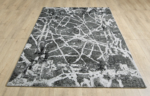 Abstract black and white rug on a wooden floor