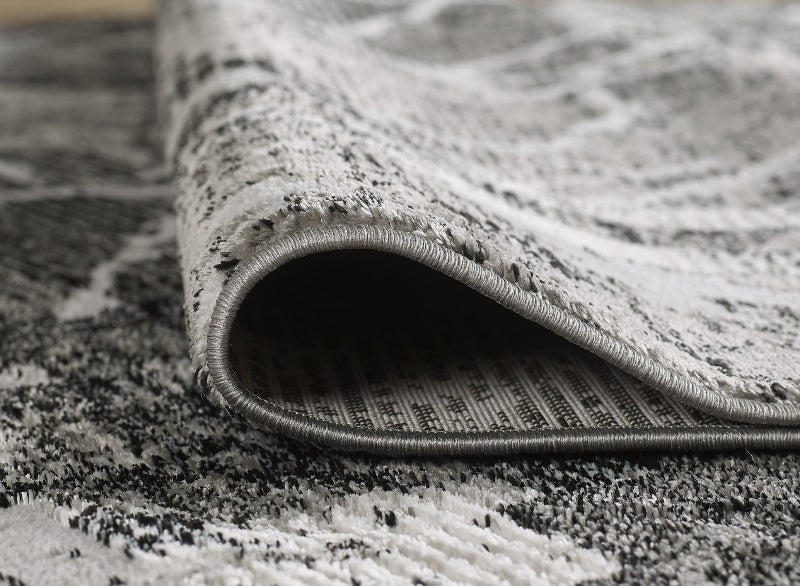 Close-up of a patterned rug with a focus on the edge.