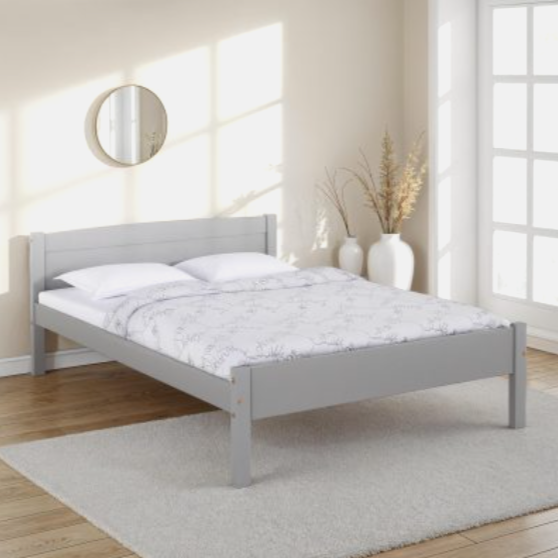 Gray bed frame with white bedding in a bright bedroom