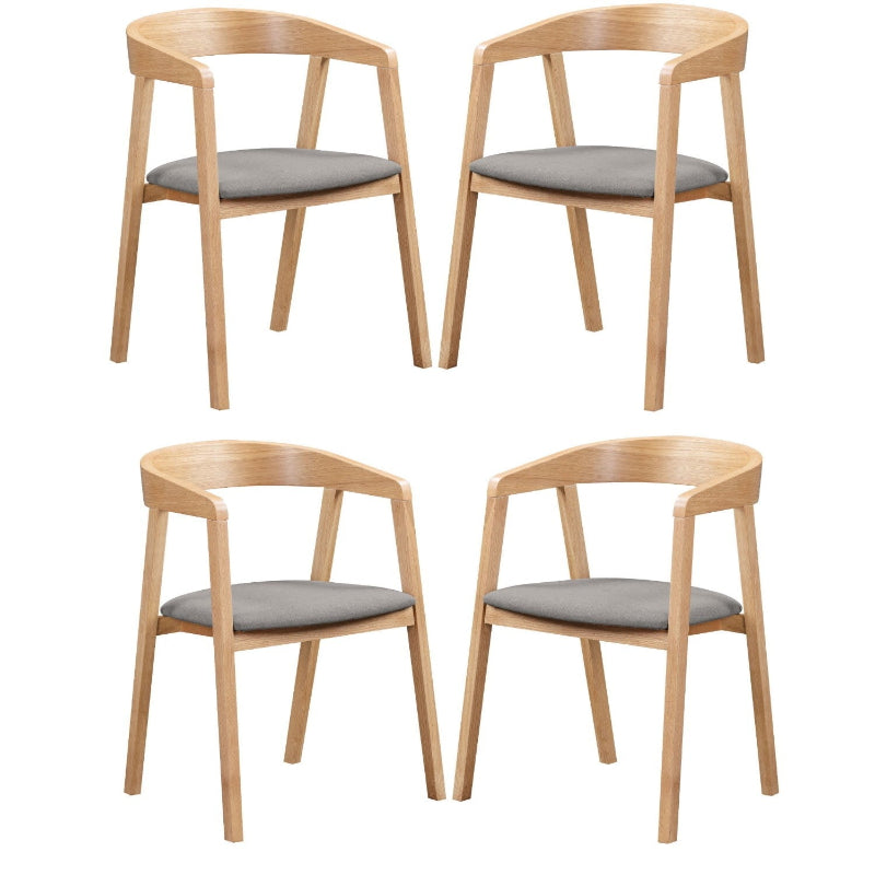 A Anders Oak Dining Chair with a beige upholstered seat and a wooden frame