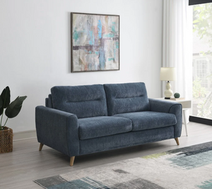 Blue sofa in a living room with abstract art and decor