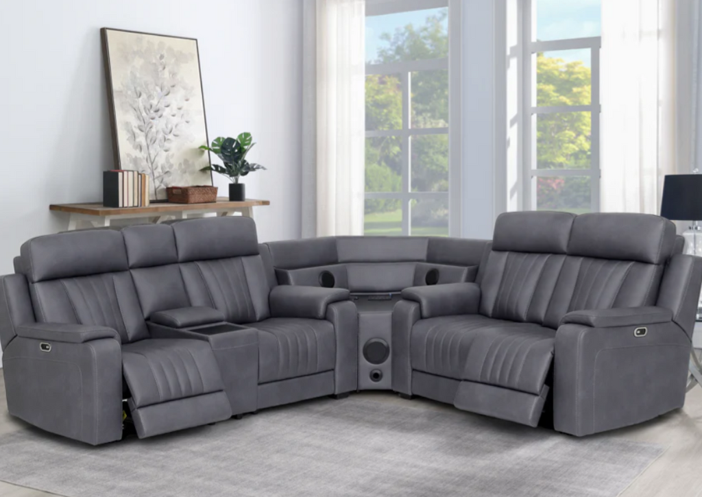 Gray sectional sofa in a living room with large windows.