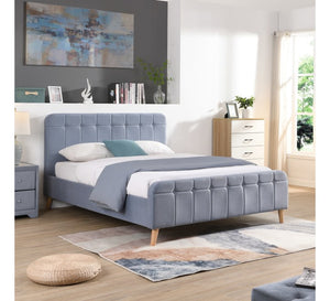 Sky Blue upholstered bed in a modern bedroom with abstract art and decor.