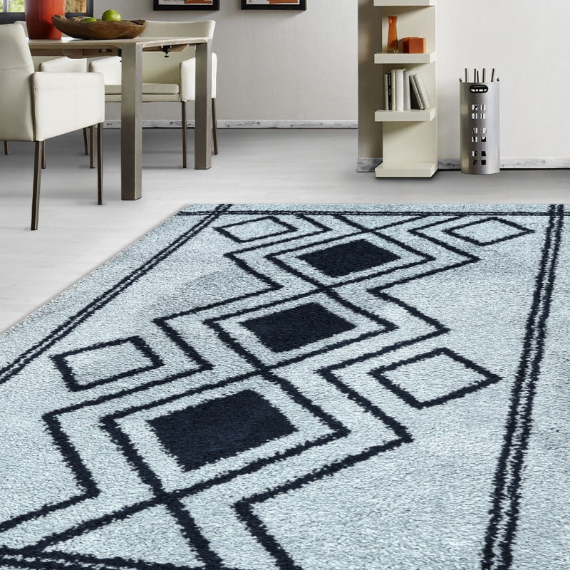 Geometric patterned rug on a light-colored floor with a dining area in the background.