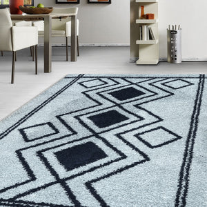 Geometric patterned rug on a light-colored floor with a dining area in the background.