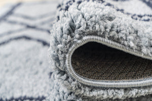 Close-up of a textured blue and white rug corner