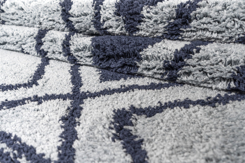 Close-up of a textured blue and navy patterned rug