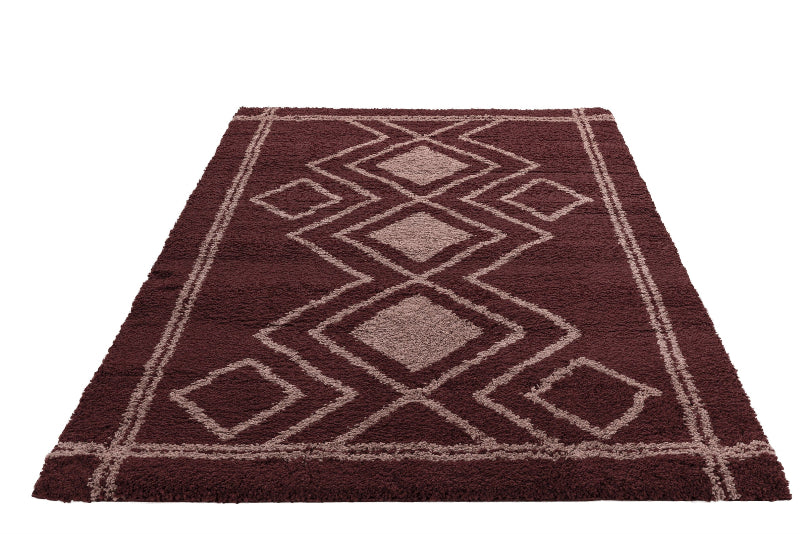 Burgundy rug with geometric pattern on a white background