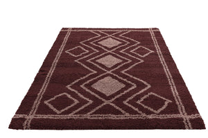 Burgundy rug with geometric pattern on a white background