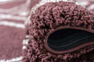 Close-up of a textured Burgundy fabric with a zipper