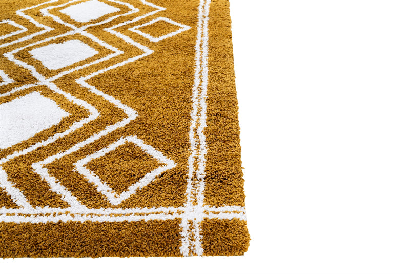 Close-up of a brown rug with white geometric patterns on a white background