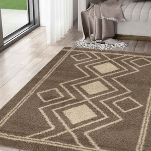 Geometric patterned rug on a wooden floor with a couch and blanket in the background