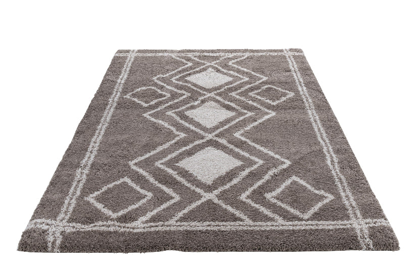 Gray and white geometric patterned rug on a white background