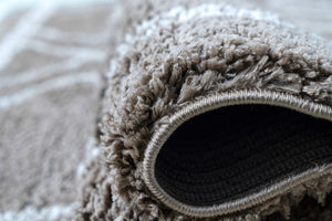 Close-up of a textured brown rug with a rolled edge