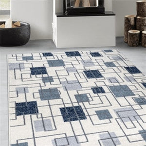 Geometric patterned rug on a floor with a fireplace and logs in the background
