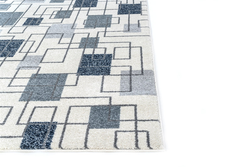 Geometric patterned rug with blue and gray squares on a white background