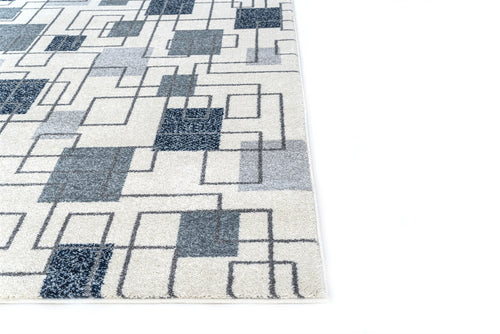 Geometric patterned rug with blue and gray squares on a white background