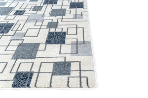 Geometric patterned rug with blue and gray squares on a white background