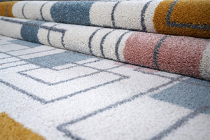 Close-up of patterned rugs with geometric designs in various colors.