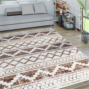 Patterned rug on a wooden floor with a gray sofa and decorative items in the background