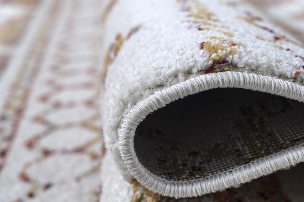 Close-up of a textured rug with a focus on the border and pile.