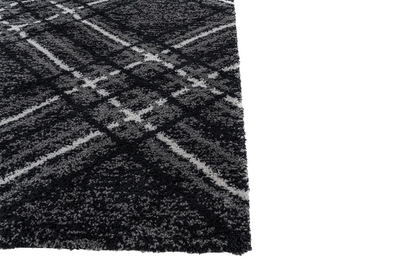 Close-up of a textured black and gray rug with a checkered pattern.
