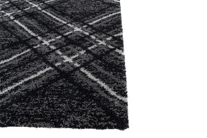 Close-up of a textured black and gray rug with a checkered pattern.