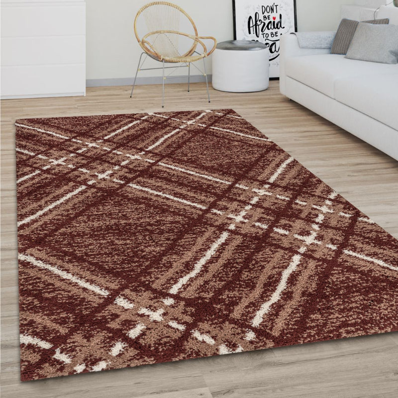 Brown and beige checkered rug on a wooden floor in a living room setting.