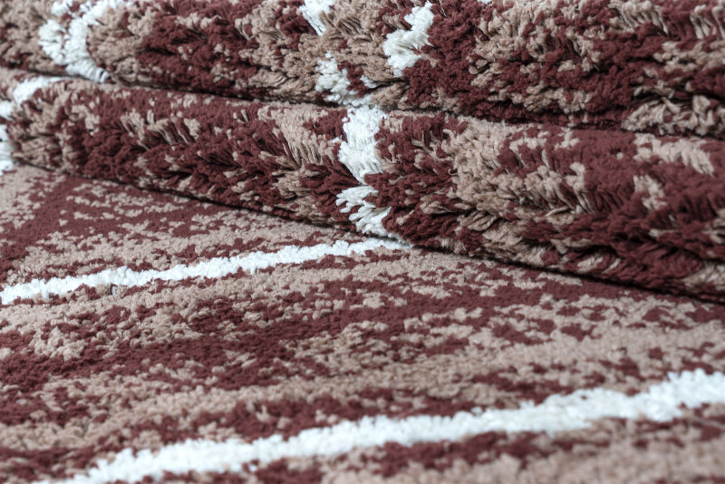 Stack of maroon and beige patterned towels