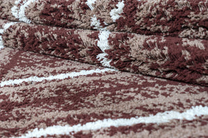 Stack of maroon and beige patterned towels