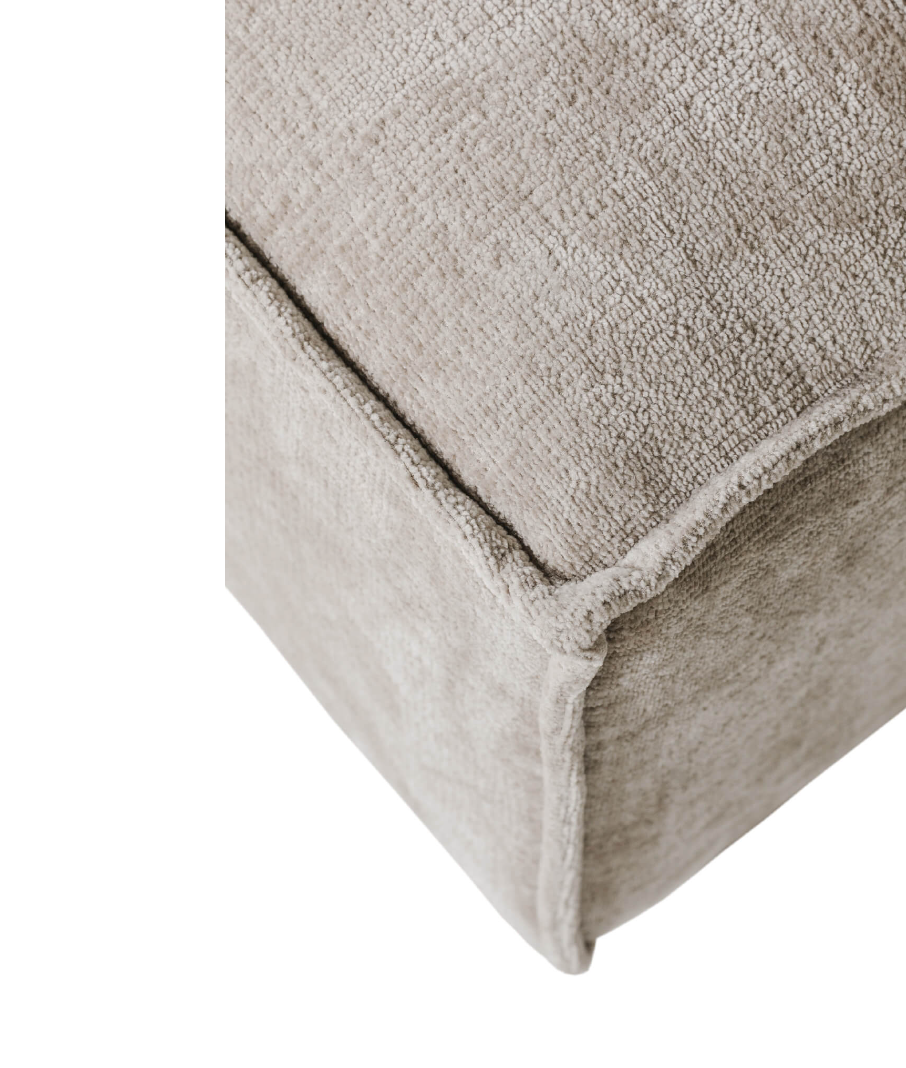 Close-up of a textured beige fabric corner on a white background