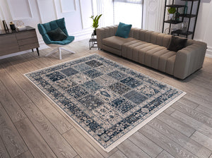 Patterned area rug on a wooden floor with a sofa and chair in a living room setting.