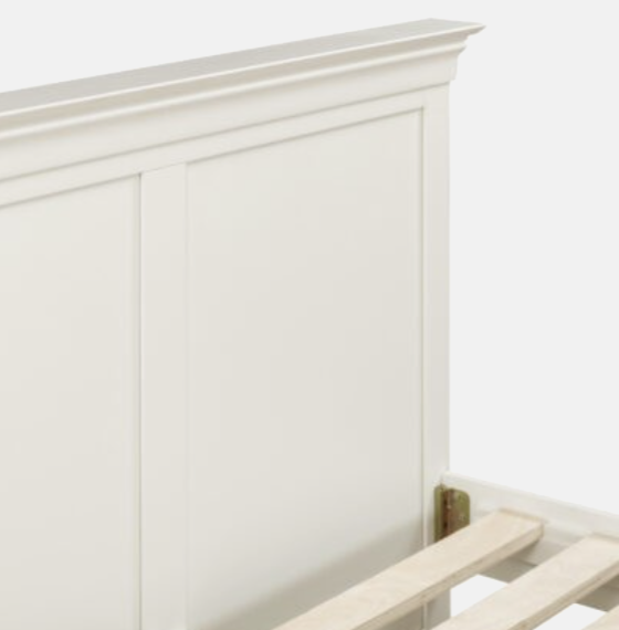 White wooden headboard with a bench at the foot of the bed on a white background