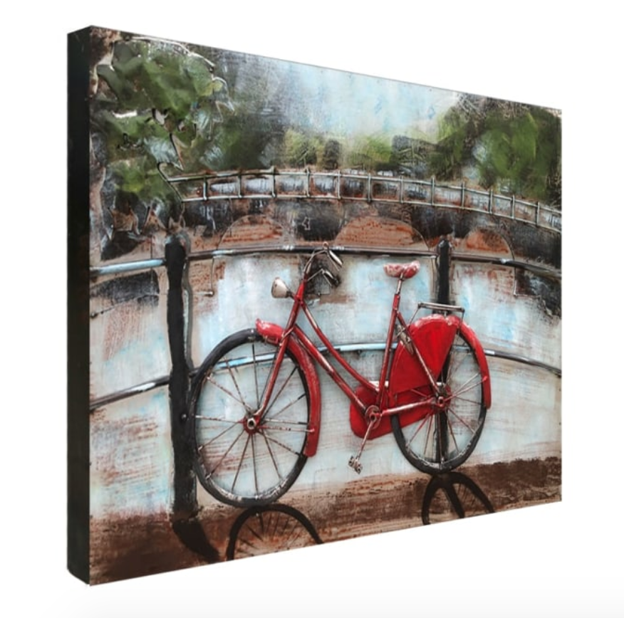 Canvas print of a red bicycle leaning against a fence with a bridge and trees in the background.