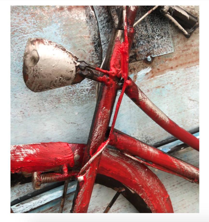 Close-up of a red bicycle with a metallic bell on a textured background