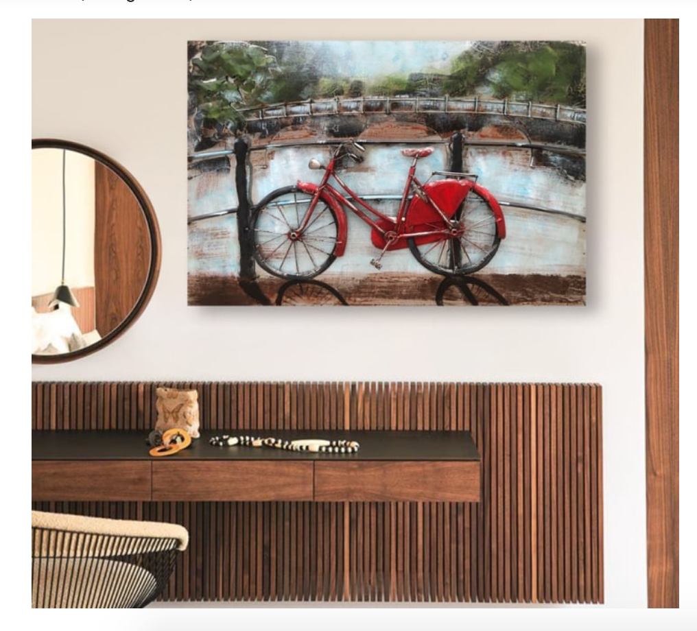 Decorative wall art of a red bicycle by a river with a wooden console table below.