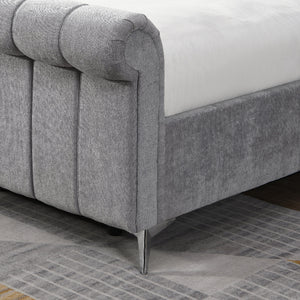 Gray upholstered bed with tufted design on a tiled floor
