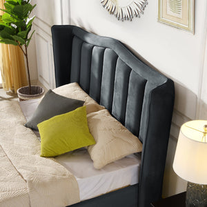 Gray upholstered headboard with decorative pillows on a bed in a bedroom setting.