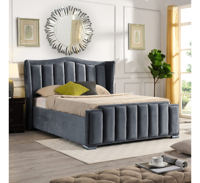 Gray upholstered bed in a stylish bedroom with decor elements.