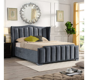 Gray upholstered bed in a stylish bedroom with decor elements.
