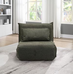 Green bean bag chair in a room with a bookshelf and windows.