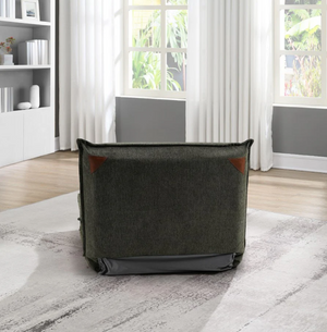 Gray armchair in a room with large windows and white curtains