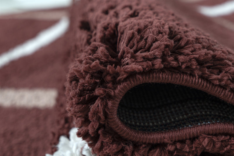 Close-up of a brown textured rug with a focus on the edge.